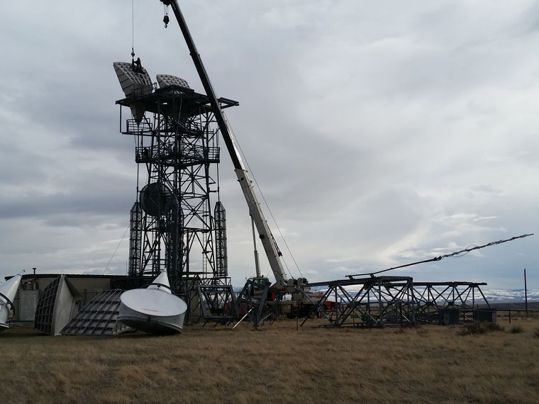 Crane alongside a tower during a structural modification