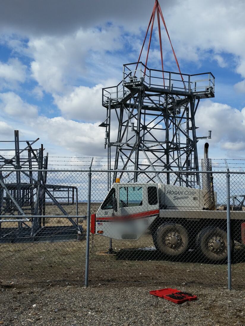 Tower top section rigged in slings and lifted clear during a dismantle
