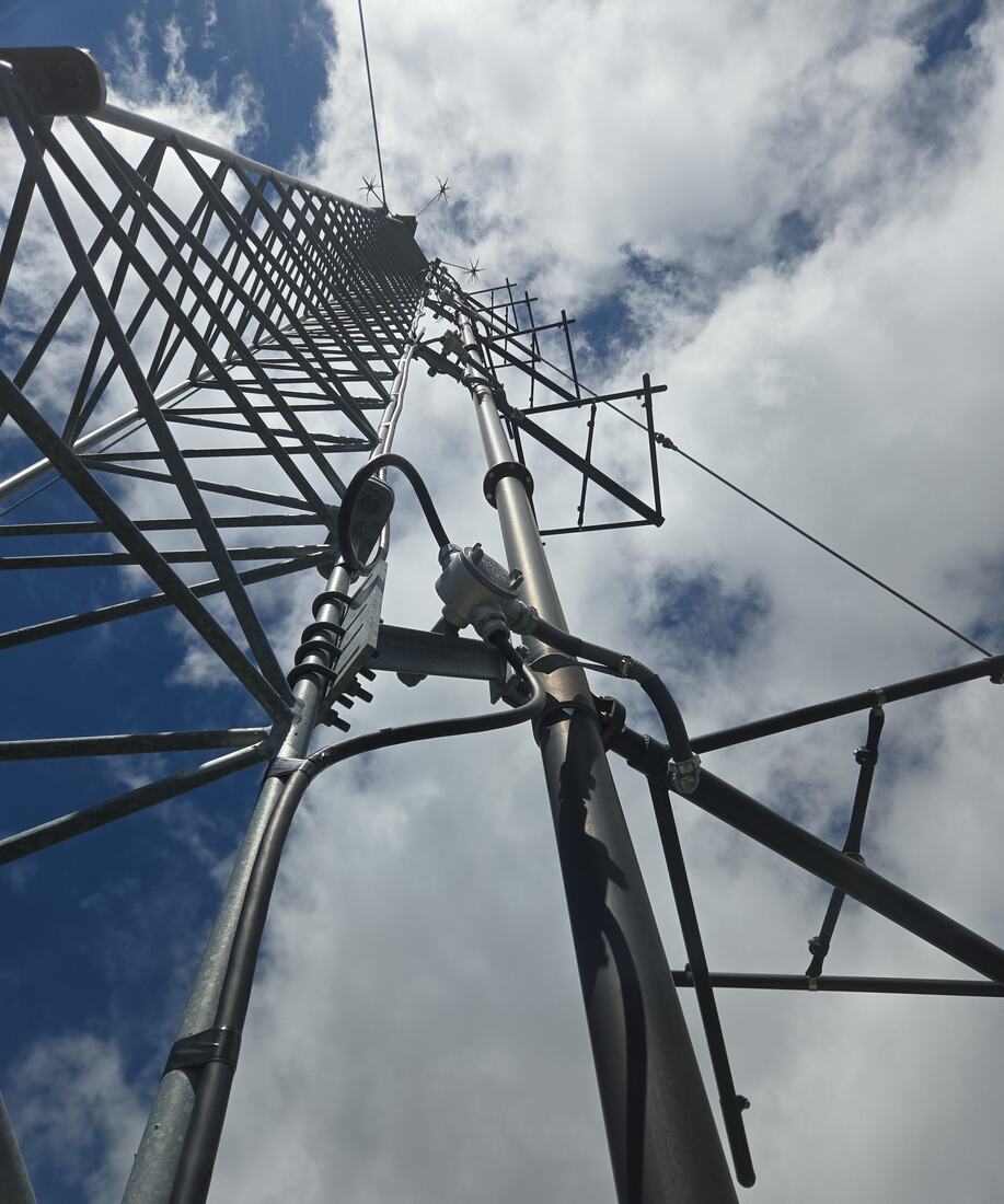 Looking up a self-support tower at a new top mount, dipole array and lightning rods