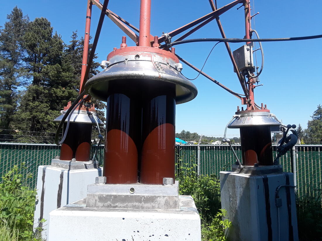 Base insulators of an AM broadcast tower inside the compound fence
