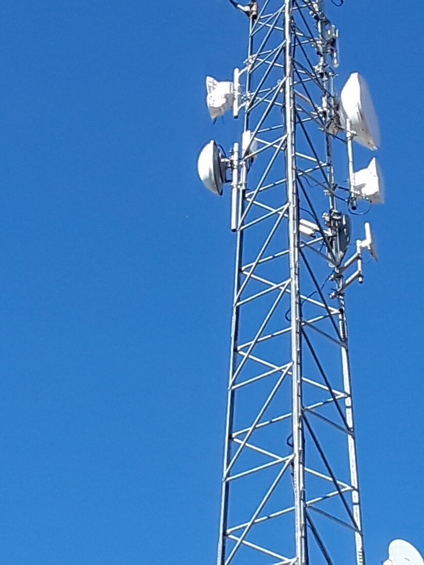 Self-support tower carrying microwave dishes, viewed from below
