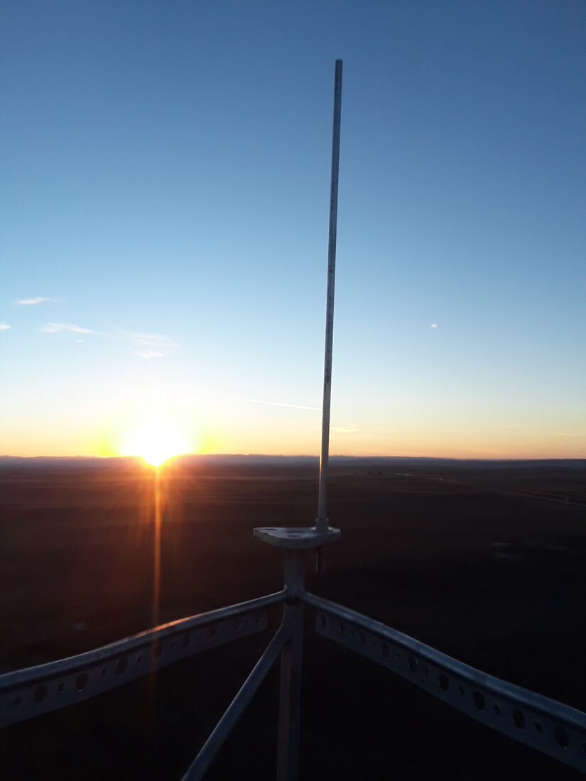 Sun rising over the plains, photographed from the top of a guyed tower