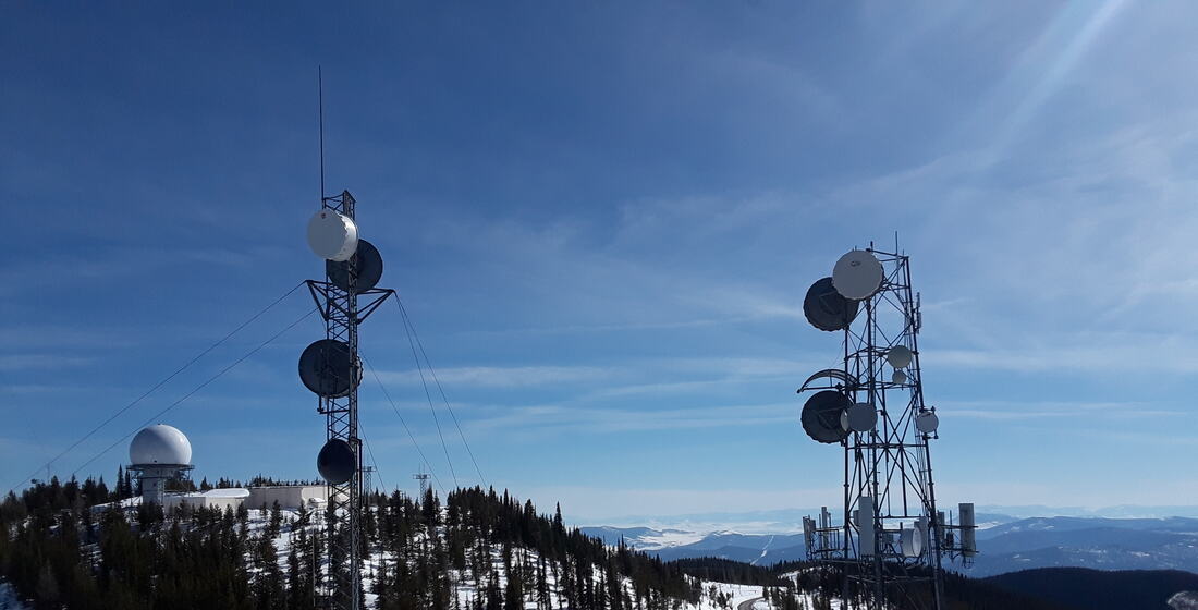 Lattice towers and a radome on a snowy mountaintop