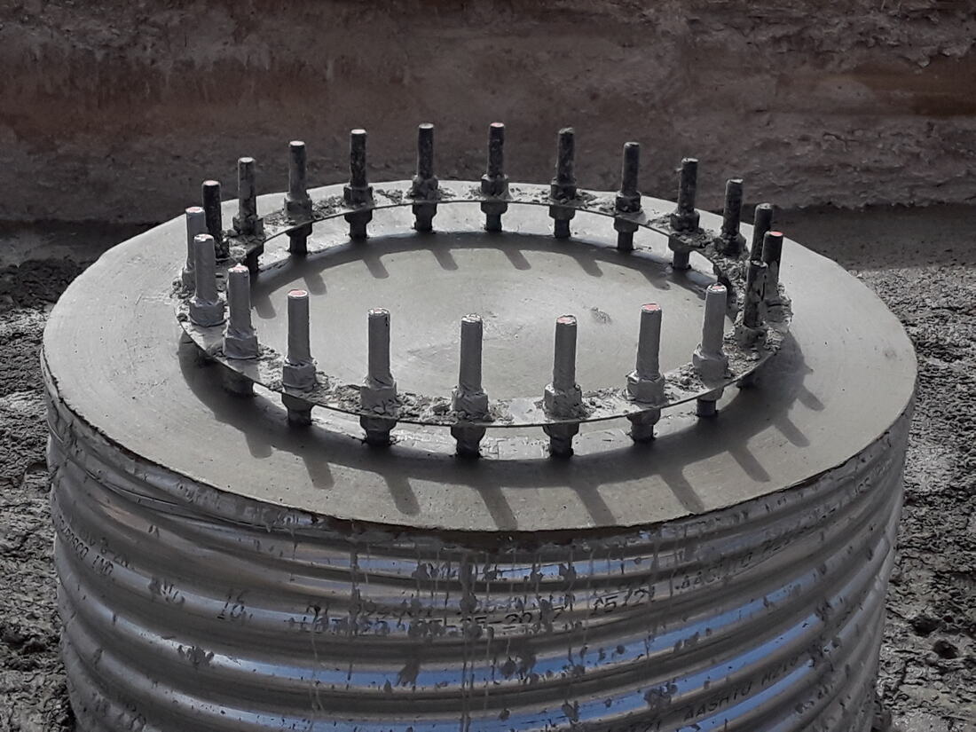 Finished concrete pier with the anchor bolt circle exposed
